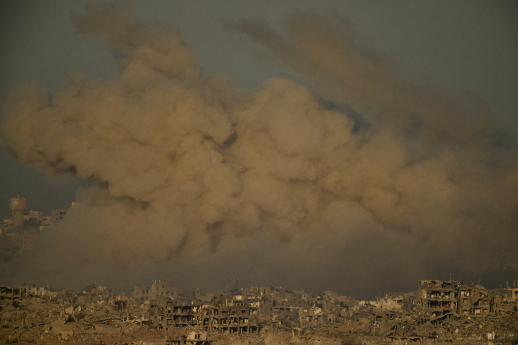 Buildings that were destroyed during the Israeli ground and air operations are engulfed by smoke following an Israeli military strike in the northern Gaza Strip, as seen from southern Israel, Saturday, Sept. 20, 2025. (AP Photo/Leo Correa)