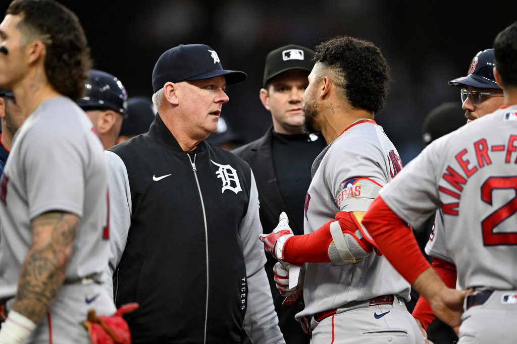 Detroit Tigers manager A.J. Hinch, left, talks with Boston Red Sox's Willson Contreras after Trevor Story was hit by a pitch during the fourth inning of a baseball game, Tuesday, May 5, 2026, in Detroit. (AP Photo/Jose Juarez)