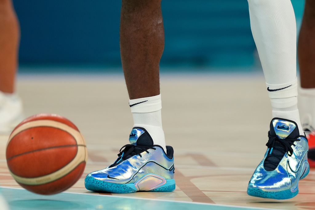 FILE - United States' LeBron James (6) wears shiny shoes while warming up during a men's gold medal basketball game against France at Bercy Arena at the 2024 Summer Olympics, Saturday, Aug. 10, 2024, in Paris, France. (AP Photo/Rebecca Blackwell, File)