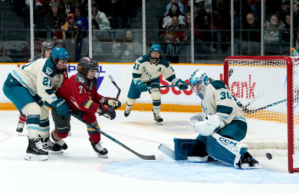 Seattle Torrent goaltender Corinne Schroeder (30) makes a save as Hilary Knight (21) defends against Ottawa Charge's Fanuza Kadirova (71) during first period PWHL hockey action in Ottawa, on Wednesday, Jan. 28, 2026. (Justin Tang/The Canadian Press via AP)