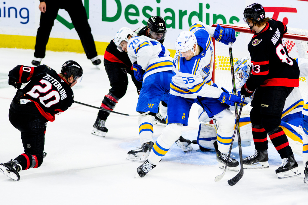 Ottawa Senators' Fabian Zetterlund (20) scores against St. Louis Blues goaltender Joel Hofer, seocnd from right, during third-period NHL hockey game action in Ottawa, Ontario, Saturday, Dec. 6, 2025. (Spencer Colby/The Canadian Press via AP)