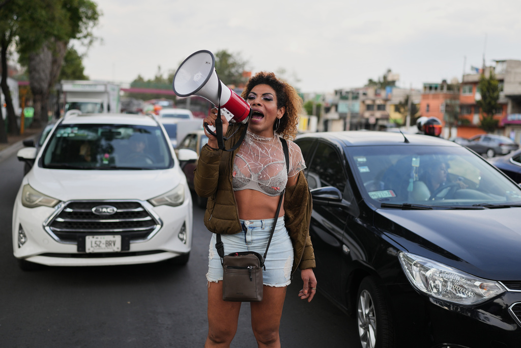 Carolina, a sex worker, protests outside a city office responsible for the construction of a bike lane ahead of the World Cup soccer tournament, which blocks cars from pulling over along Calzada de Tlalpan and closes the metro at night, in Mexico City, Friday, Jan. 23, 2026. (AP Photo/Eduardo Verdugo)
