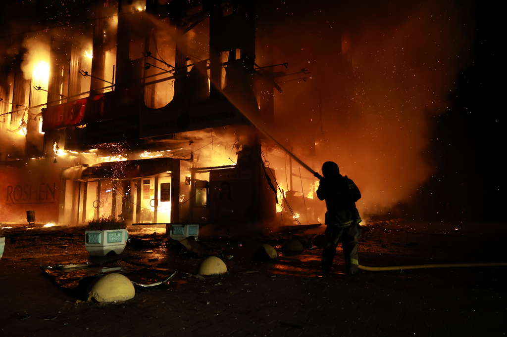 A rescue worker puts out a fire at the Intrade trade center after a Russian drone strike on Zaporizhzhia, Ukraine, Monday, Sept. 21, 2026. (AP Photo/Kateryna Klochko) Correction: Byline corrected to Kateryna Klochko, instead of Evgeniy Maloletka
