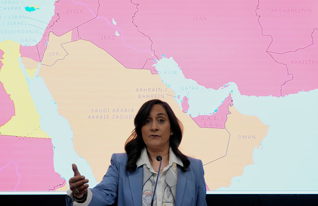 A map showing travel advisory risk levels in the Middle East is shown behind Canada's Minister of Foreign Affairs Anita Anand as she speaks at a news conference at the Emergency Watch and Response Centre at Global Affairs Canada in Ottawa, Ontario, Wednesday, March 4, 2026. (Justin Tang/The Canadian Press via AP)