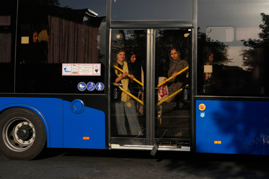 Commuters ride a bus in downtown Tehran, Iran, Monday, Aug. 17, 2026. (AP Photo/Vahid Salemi)