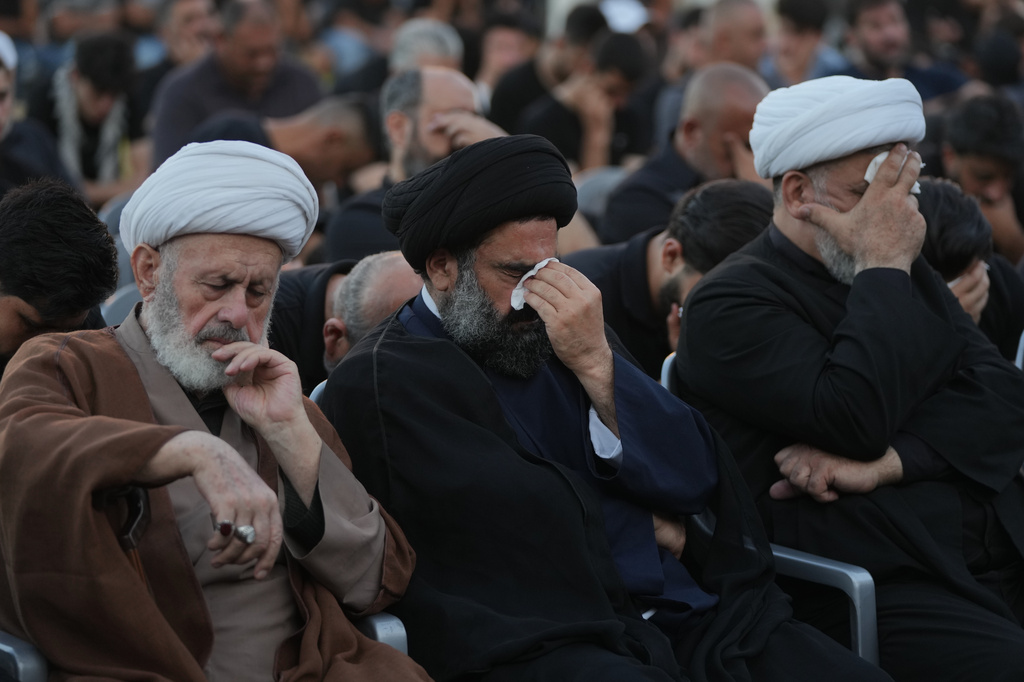 Shiite clerics and mourners weep during a sermon marking the third day of Ashoura, the Shiite Muslim commemoration of the 7th-century death of Imam Hussein, the grandson of the Prophet Muhammad, in the southern port city of Tyre, Lebanon, Friday, June 19, 2026. (AP Photo/Hassan Ammar)