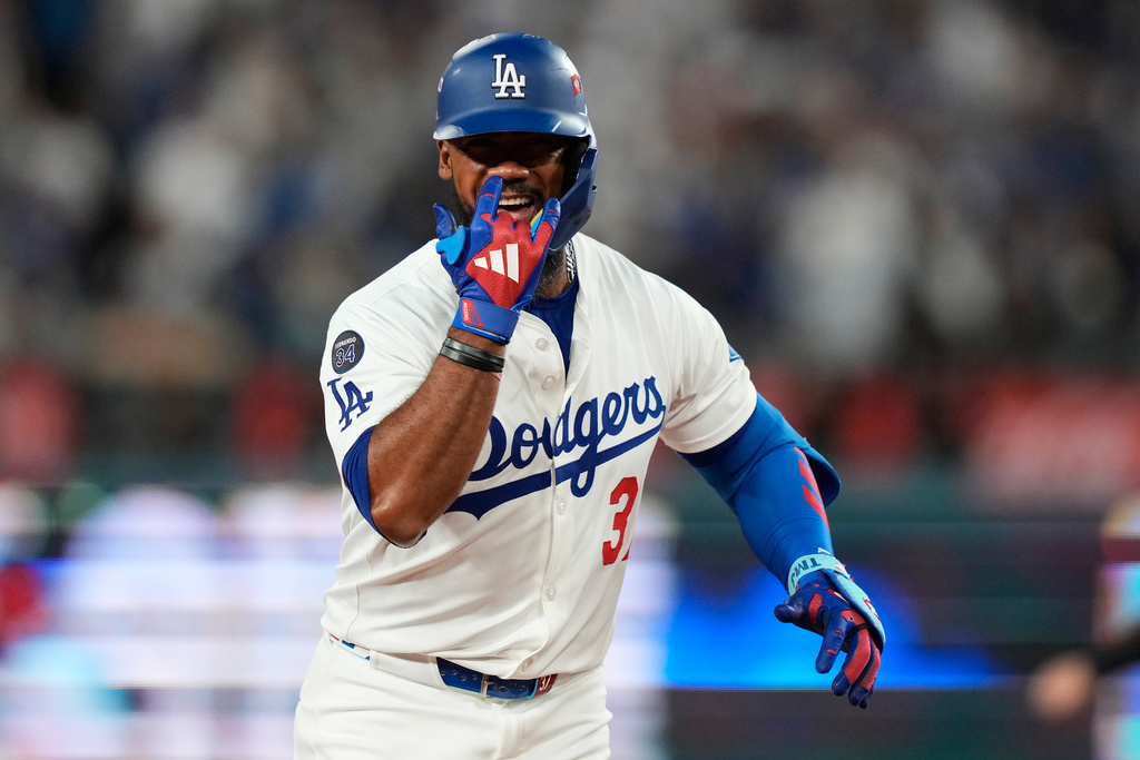 Los Angeles Dodgers' Teoscar Hernández celebrates after hitting a three-run home run during the third inning in Game 1 of the National League Wild Card baseball playoff series against the Cincinnati Reds, Tuesday, Sept. 30, 2025, in Los Angeles. (AP Photo/Mark J. Terrill)
