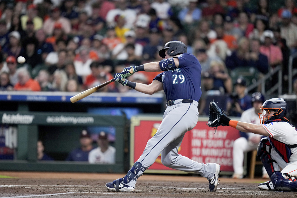Seattle Mariners' Cal Raleigh (29) hits a solo home run, his 57th of the season, against the Houston Astros during the third inning of a baseball game Saturday, Sept. 20, 2025, in Houston. (AP Photo/Eric Christian Smith)