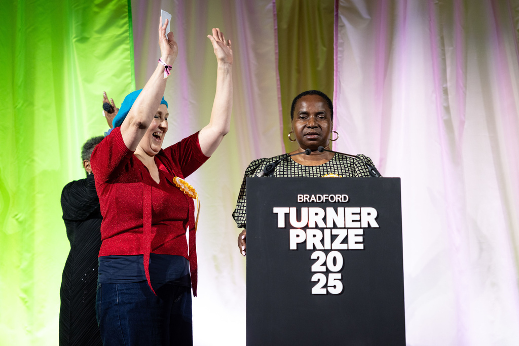 Nnena Kalu, right, is announced as the winner of the Turner Prize 2025 at a ceremony at Bradford Grammar School, in Bradford, England, Tuesday Dec. 9, 2025. (James Speakman/PA via AP)