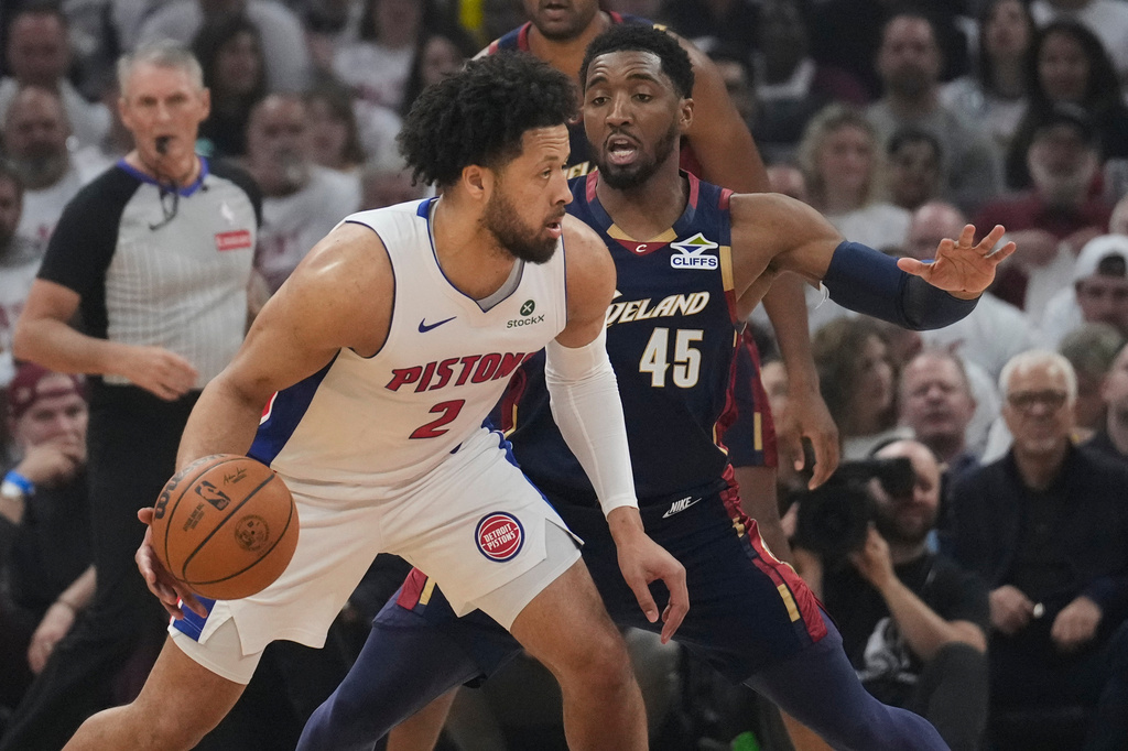 Detroit Pistons guard Cade Cunningham (2) drives against Cleveland Cavaliers guard Donovan Mitchell (45) in the first half of Game 3 of a second-round NBA playoffs basketball series Saturday, May 9, 2026 in Cleveland. (AP Photo/Sue Ogrocki)