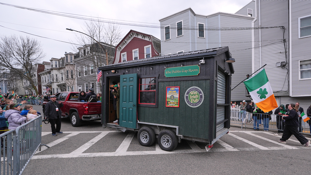 The "Wee Irish Pub", a fully functioning mobile Irish pub built by two Massachusetts' brothers, is towed during the annual St. Patrick's Day parade through the South Boston neighborhood, Sunday, March 15, 2026. (AP Photo/Charles Krupa)