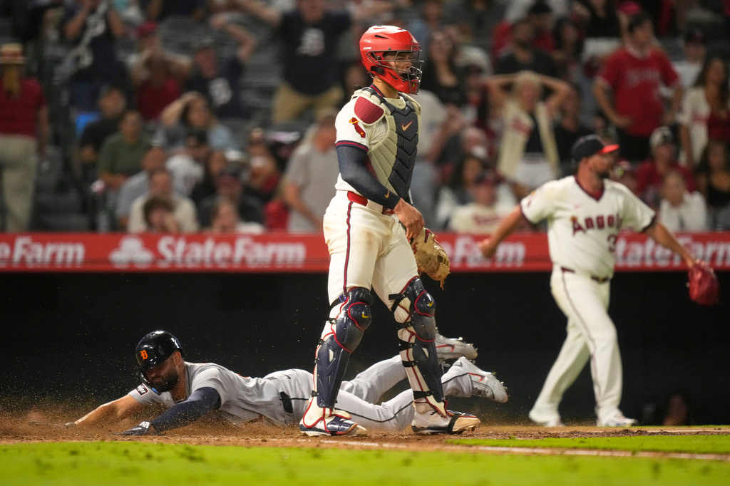 Detroit Tigers' Riley Greene, left, scores on a double by Hao-Yu Lee as Los Angeles Angels catcher Logan O'Hoppe stands by during the ninth inning of a baseball game Friday, July 17, 2026, in Anaheim, Calif. (AP Photo/Mark J. Terrill)