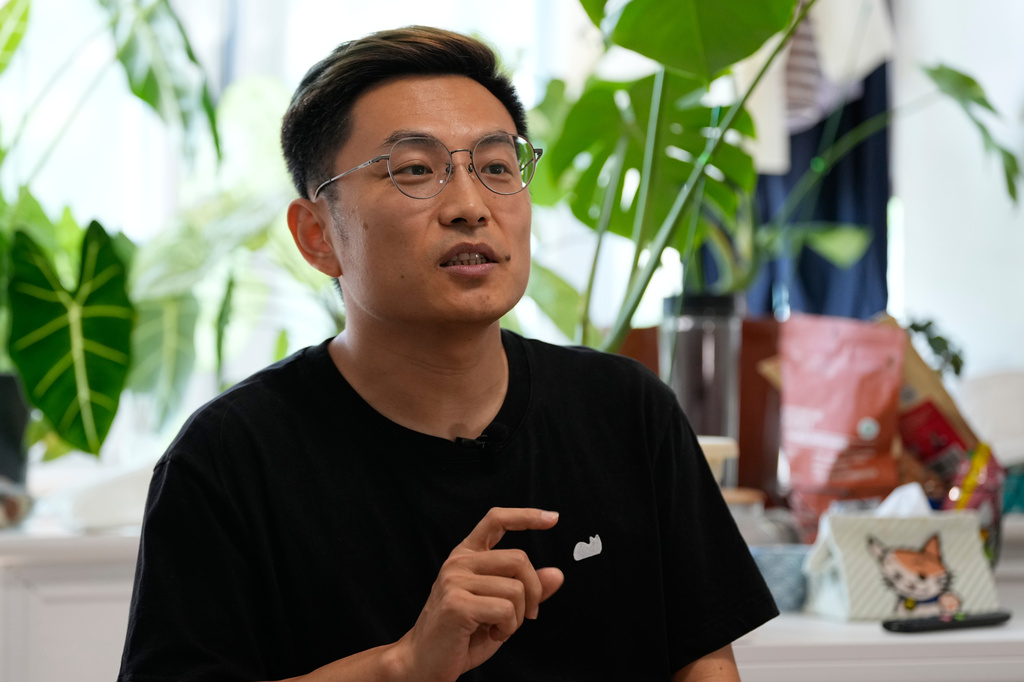 Fei Zhaojun, a former software engineer speaks during an interview at his home in Beijing on July 13, 2026. (AP Photo/Andy Wong)