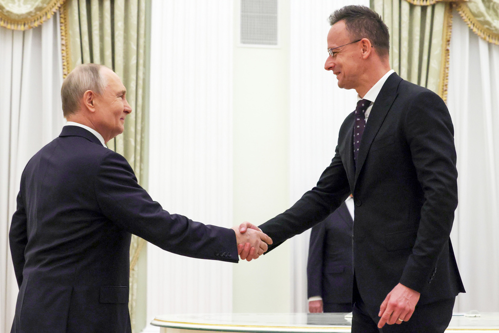 Russian President Vladimir Putin, left, and Hungarian Foreign Minister Peter Szijjarto shake hands during their meeting at the Senate Palace of the Kremlin in Moscow, Wednesday, March 4, 2026. (Mikhail Metzel, Sputnik, Kremlin Pool Photo via AP)
