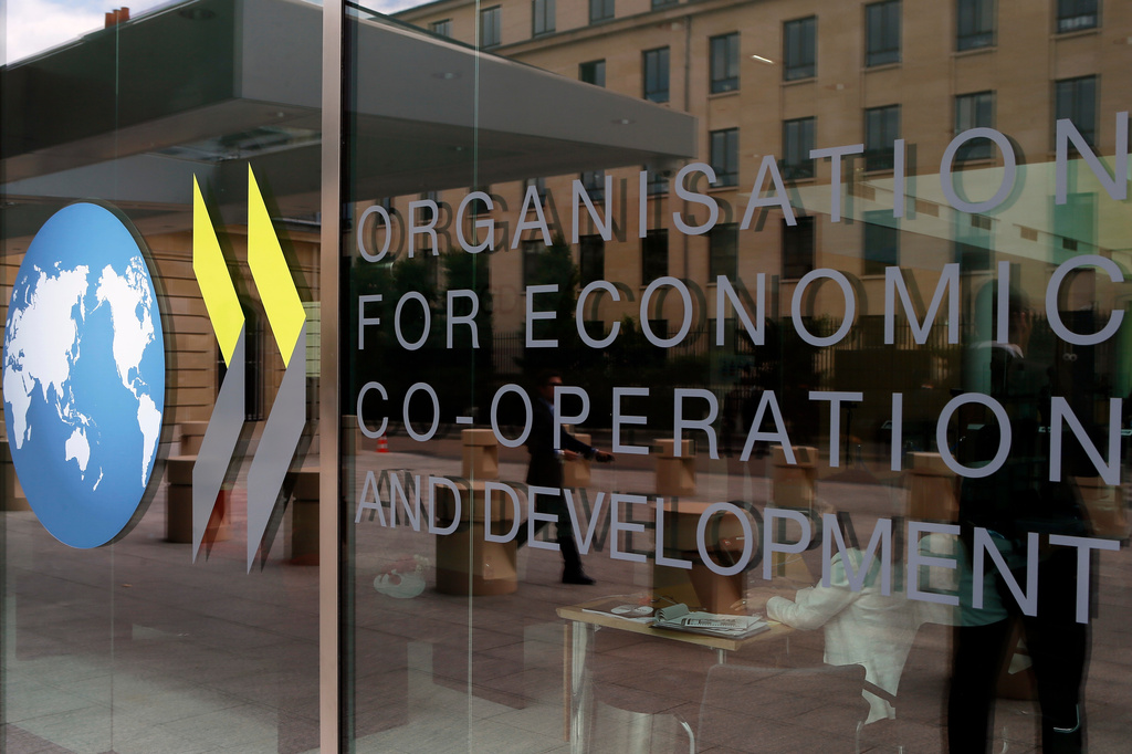 FILE - The logo at the entrance of the Organisation for Economic Co-operation and Development (OECD) headquarters in Paris, France, Wednesday, June 7, 2017. (AP Photo/Francois Mori, file)