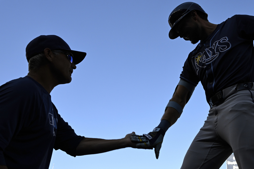 Tampa Bay Rays' Josh Lowe, right, is greeted by Tampa's Kevin Cash after hitting a three-run home run against Washington Nationals pitcher Jake Irvin during the first inning of a baseball game, Saturday, Aug. 30, 2025, in Washington. (AP Photo/Terrance Williams)