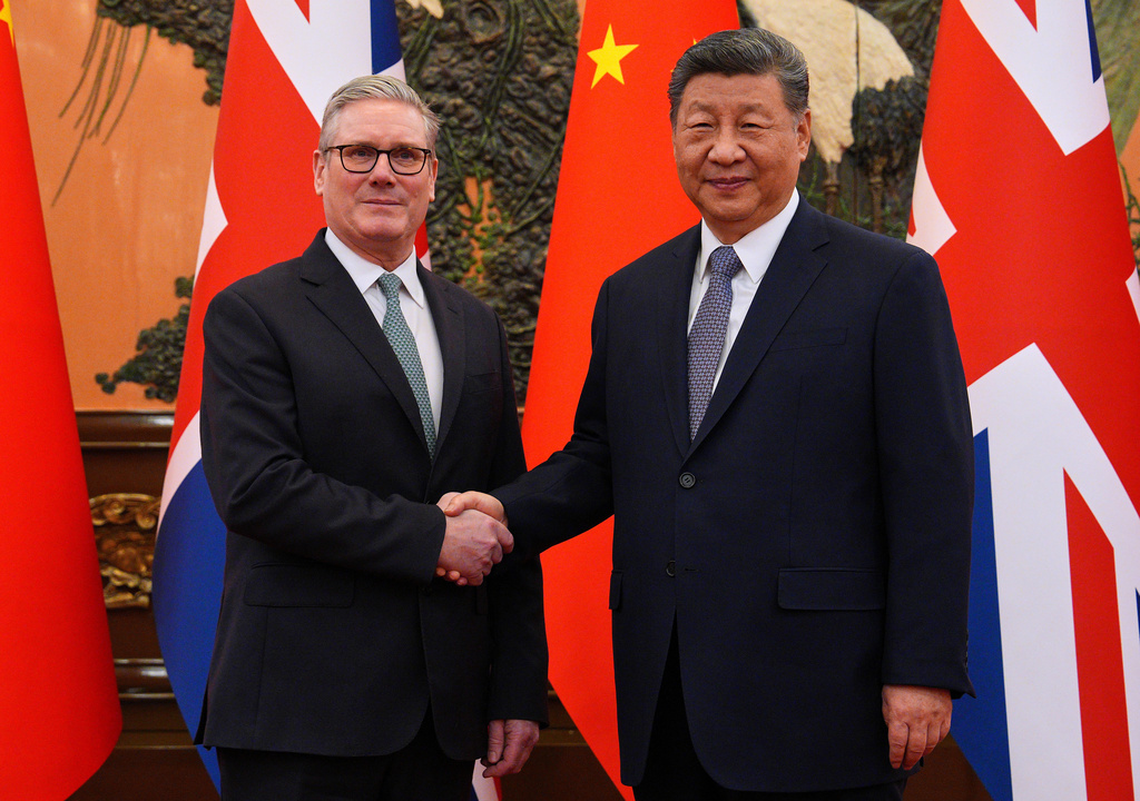 Britain's Prime Minister Keir Starmer, left, shakes hands with Chinese President Xi Jinping ahead of a bilateral meeting in Beijing, China, Thursday, Jan.29, 2026. (Carl Court/Pool Photo via AP)