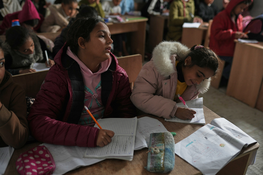 Palestinian children attend class in a tent classroom at an orphanage camp in Khan Younis, southern Gaza Strip, Thursday, Feb. 12, 2026. (AP Photo/Jehad Alshrafi)