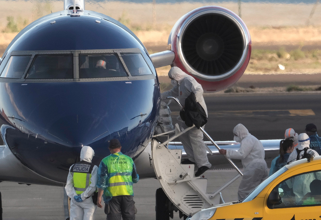 Passengers board a plane bound for Eindhoven, after disembarking from the hantavirus-stricken cruise ship MV Hondius at the airport in Tenerife, Canary Islands, Spain, Monday, May 11, 2026. (AP Photo/Arturo Rodriguez)