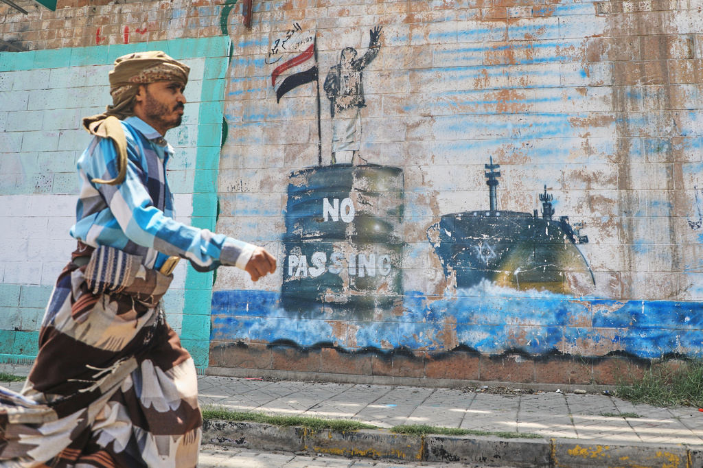 A man walks in front of a mural symbolising restrictions on shipping through the Bab el-Mandeb Strait, one of the world's key shipping lanes, in Sanaa, Yemen, Monday, Sept. 14, 2026. (AP Photo/Osamah Abdulrahman)