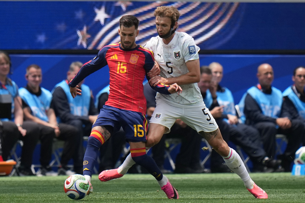 Spain's Alex Baena (15) challenges for the ball against Austria's Stefan Posch (5) during the World Cup round of 32 soccer match between Spain and Austria in Inglewood, Calif., near Los Angeles, Thursday, July 2, 2026. (AP Photo/Jae C. Hong)