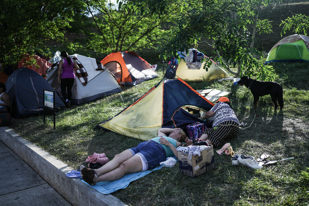 People evacuated from their earthquake-damaged homes camp in a park three days after a quake hit Cali, Colombia, Thursday, Aug. 13, 2026. (AP Photo/Ivan Valencia)