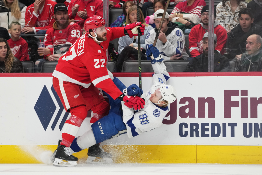 Detroit Red Wings center Michael Rasmussen, left, collides with Tampa Bay Lightning defenseman J.J. Moser during the first period of an NHL hockey game Friday, Nov. 28, 2025, in Detroit. (AP Photo/Ryan Sun)