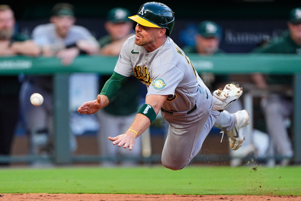 Athletics' Donovan Walton slides home to score on an RBI single hit by Henry Bolte during the fifth inning of a baseball game against the Kansas City Royals, Wednesday, Aug. 19, 2026, in Kansas City, Mo. (AP Photo/Charlie Riedel)
