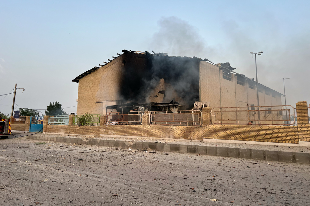Smoke rises from a building damaged in a strike in Lamerd, southern Iran, Saturday, Feb. 28, 2026. (Alireza Ameri/Tasnim News Agency via AP)