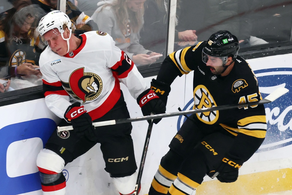 Boston Bruins' Jonathan Aspirot (45) checks Ottawa Senators' Fabian Zetterlund, left, during the first period of an NHL hockey game, Thursday, Nov. 6, 2025, in Boston. (AP Photo/Michael Dwyer)