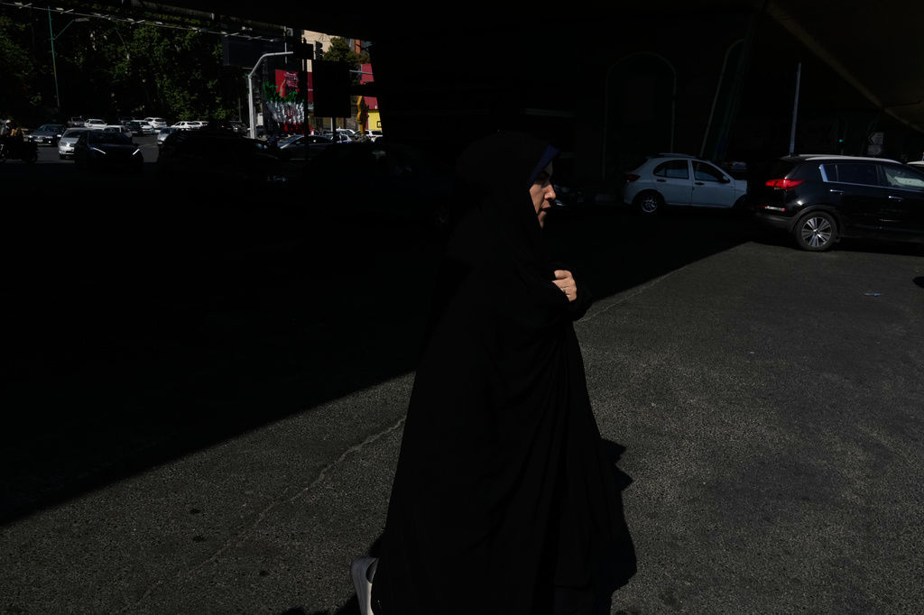 A woman crosses an intersection in northern Tehran, Wednesday, June 10, 2026. (AP Photo/Vahid Salemi)