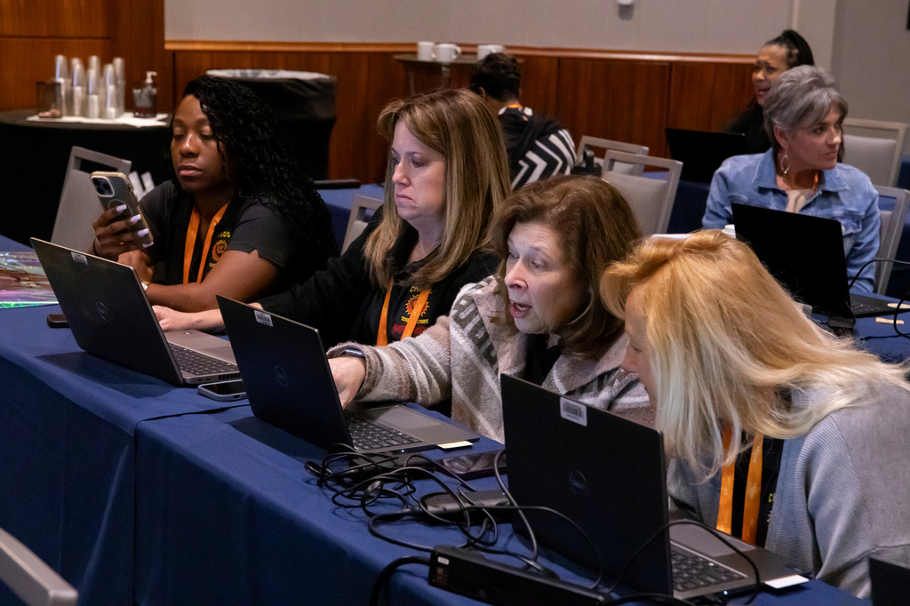 From left, Raytheon administrators Marianna Leonard, Holly Martineau, Lynn Ljunggren and Annemarie Downing workshop an AI exercise during "How To Use AI To Think and Influence at the Executive Level," an administrative training session, Wednesday, April 22, 2026, in Boston. (AP Photo/Sydney Roth)