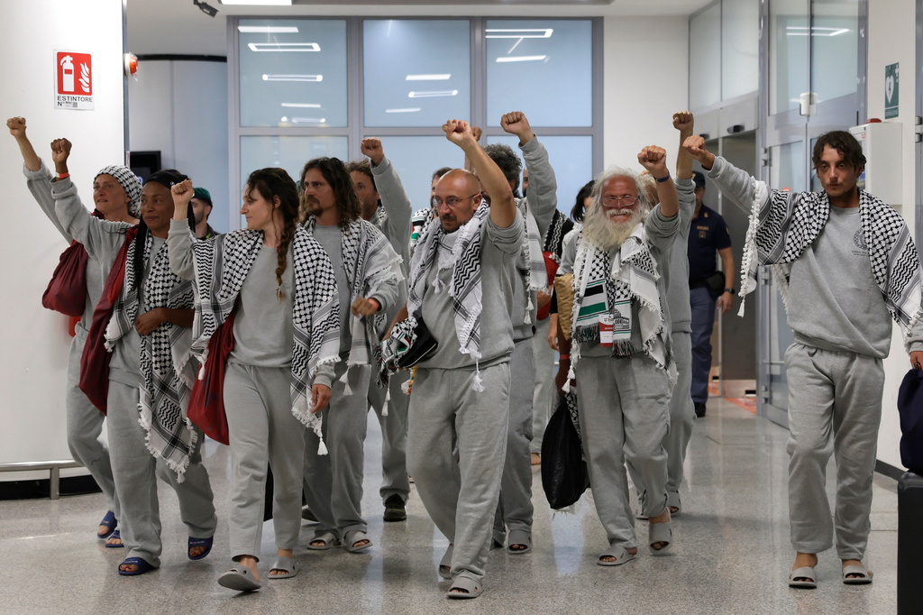 Italian members of the Global Sumud Flotilla arrive at the Fiumicino Airport in Rome on Thursday, May 21, 2026, after they were released and deported by the Israeli government after attempting to reach Gaza. (Cecilia Fabiano/LaPresse via AP)