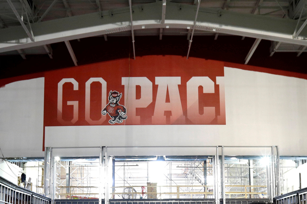 FILE - A "Go Pack" sign hangs on a wall as contractors continue renovations to Reynolds Coliseum on the North Carolina State University campus in Raleigh, N.C., May 26, 2016. (AP Photo/Gerry Broome, File)
