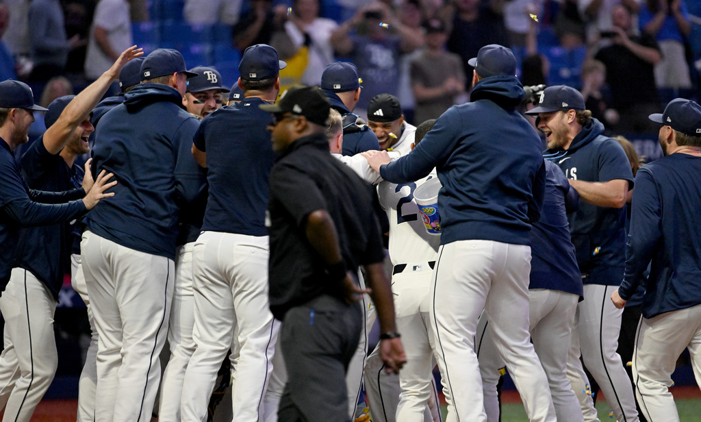 The Tampa Bay Rays celebrate Junior Caminero's walk-off home run during the ninth inning of a baseball game against the Athletics Tuesday, Sept. 15, 2026, in St. Petersburg, Fla. (AP Photo/Jason Behnken)