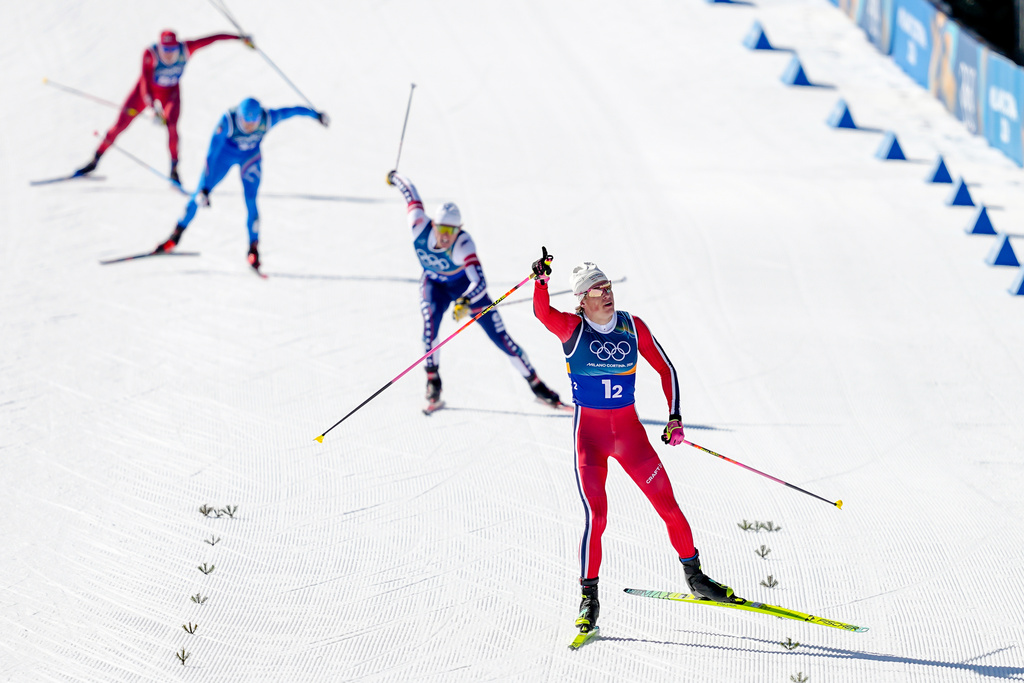 Johannes Hoesflot Klaebo, of Norway, approaches the finish line to win the gold medal in the cross-country skiing men's team sprint free at the 2026 Winter Olympics, in Tesero, Italy, Wednesday, Feb. 18, 2026. (AP Photo/Matthias Schrader)