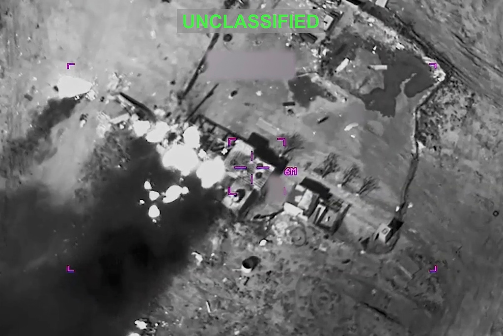 This partially redacted image from video provided by U.S. Central Command shows a complex of structures in Iran being struck by missiles fired by U.S. forces on Sunday, March 1, 2026. (U.S. Central Command via AP)