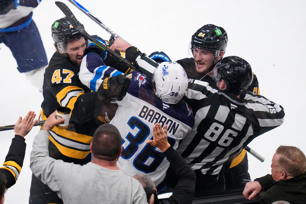 Boston Bruins center Mark Kastelic (47) and left wing Tanner Jeannot (84) tangle with Winnipeg Jets center Morgan Barron (36) during the second period of an NHL hockey game, Thursday, March 19, 2026, in Boston. (AP Photo/Charles Krupa)