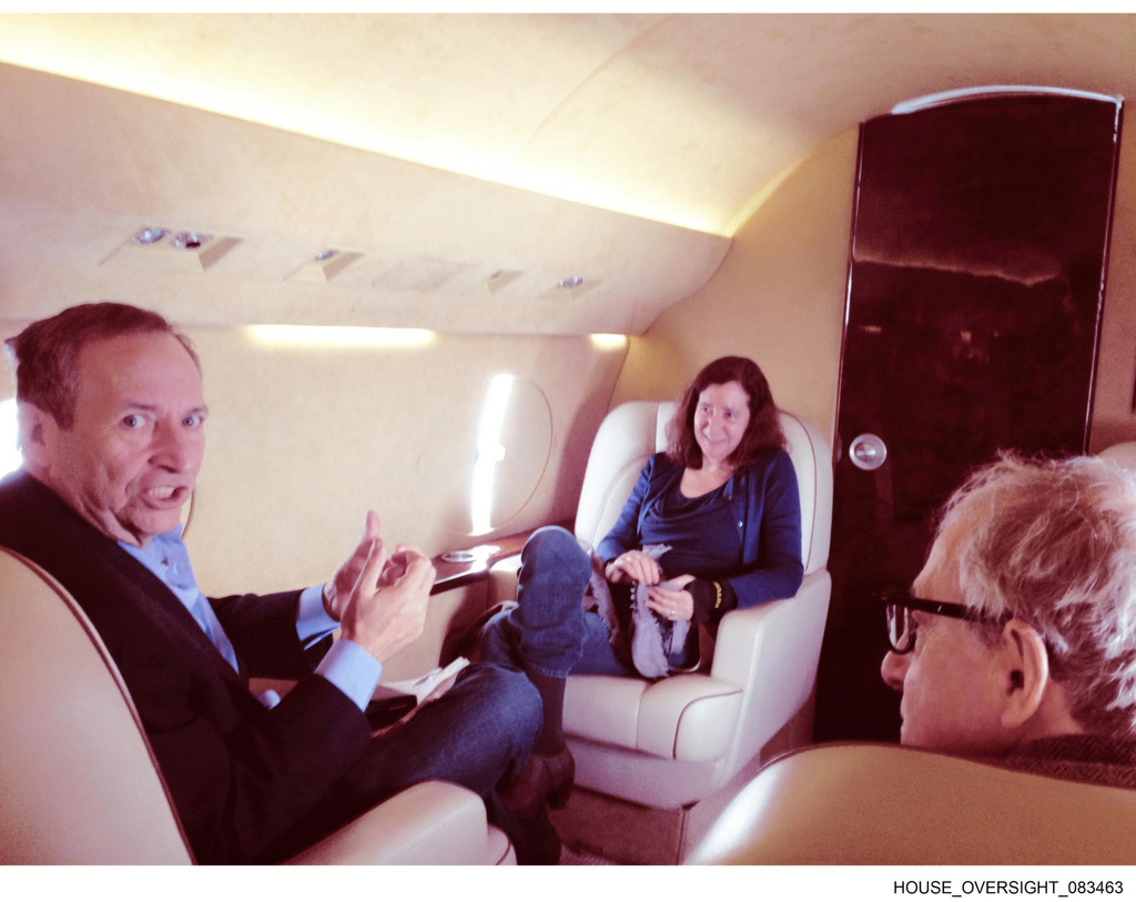 This undated photo released by Democrats on the House Oversight Committee shows Larry Summers, left, his wife, Elisa New, center, and Woody Allen on an airplane. (House Oversight Committee via AP)