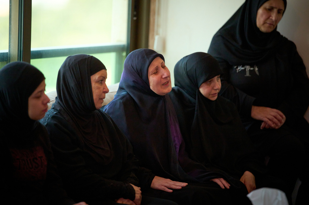 Ahlam Badawi, 51, center, mother of Hassan Ali Badawi, 31, a paramedic of the Lebanese Red Cross killed in a Israeli strike, cries during his funeral in Choueifat, Lebanon, Monday, April 13, 2026. (AP Photo/Emilio Morenatti)