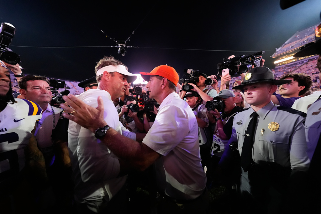 LSU head coach Lane Kiffin, left, greets Clemson head coach Dabo Swinney after an NCAA college football game, Saturday, Sept. 5, 2026 in Baton Rouge, La. (AP Photo/Gerald Herbert)