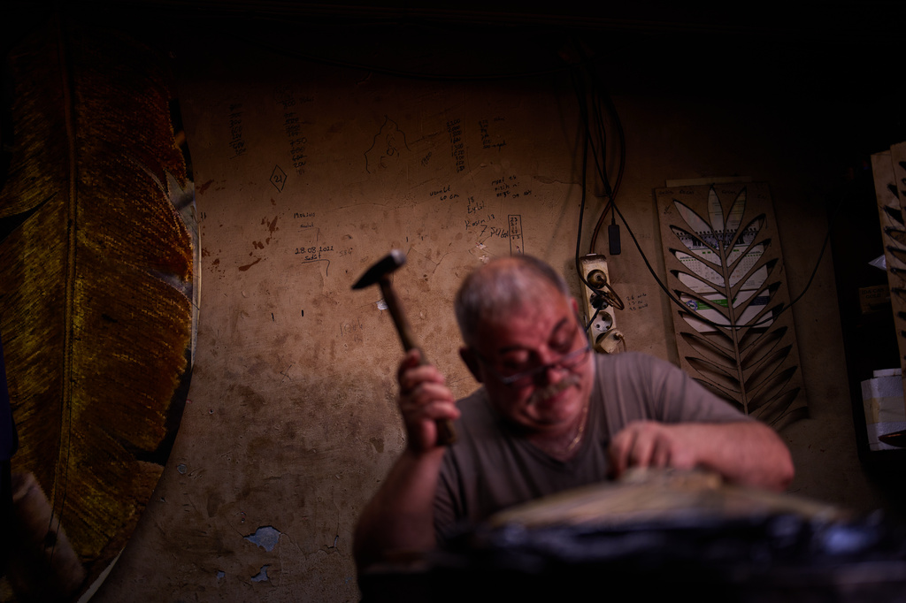 Master inlay and relief craftsman Nejat Kilic works in his workshop in Istanbul's Eminonu commercial district, Thursday, Aug. 6, 2026. (AP Photo/Francisco Seco)