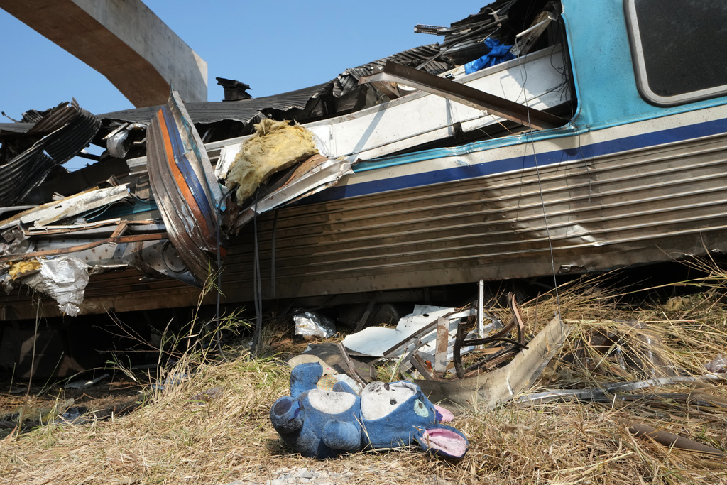 A cuddly toy lies on the ground at the site of a train accident, a day after a construction crane fell into a passenger train in Nakhon Ratchasima province, Thailand, Thursday, Jan. 15, 2026. (AP Photo/Sakchai Lalit)