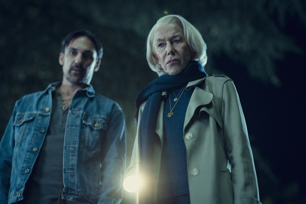 This image released by Netflix shows Henry Lloyd Hughes, left, and Helen Mirren in a scene from "The Thursday Murder Club." (Netflix via AP)