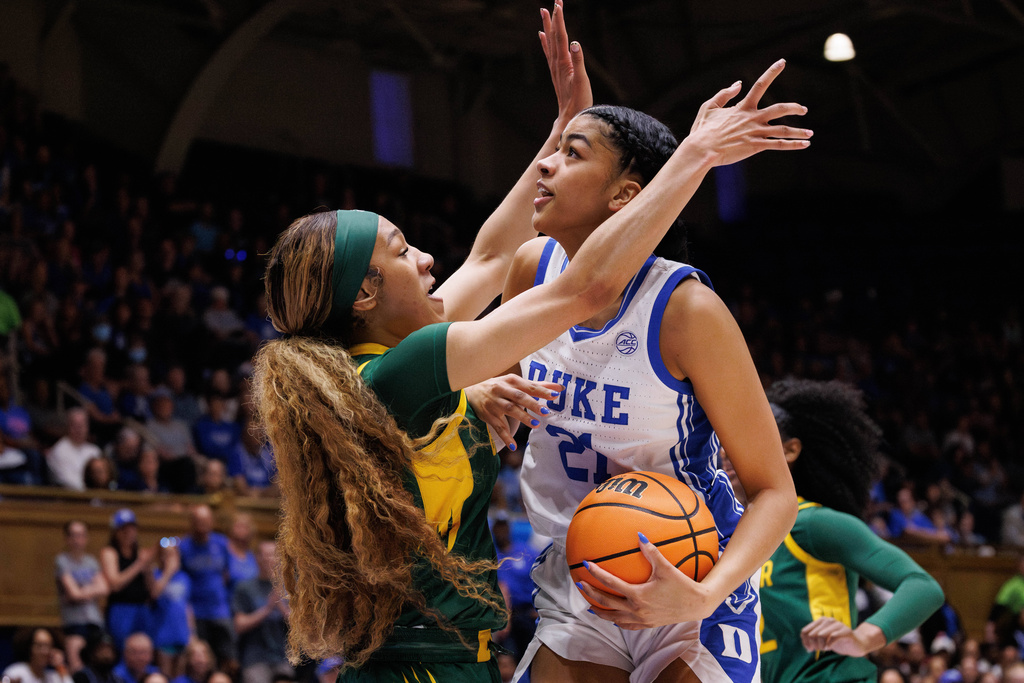 Duke's Arianna Roberson (21) handles the ball as Baylor's Darianna Littlepage-Buggs, left, defends during the first half in the second round of the NCAA college basketball tournament, Sunday, March 22, 2026 in Durham, N.C. (AP Photo/Ben McKeown)