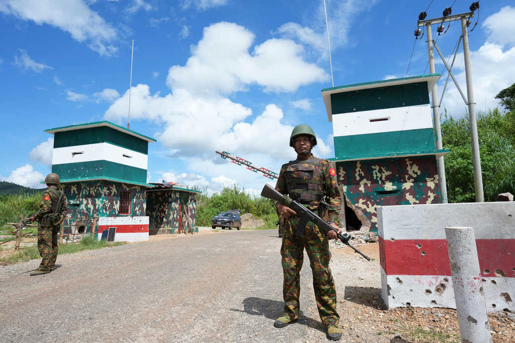 In this photo taken during a trip supervised by pro-military Myanmar media, soldiers stand guard at a check point in Kyaukme, northern Shan State, Myanmar, Friday, Oct. 10, 2025. (AP Photo/Aung Shine Oo)