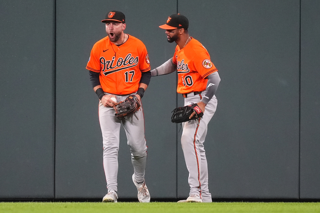 Baltimore Orioles center fielder Colton Cowser, left, yells as right fielder Leody Taveras looks on after Cowser robbed Colorado Rockies' Jake McCarthy of a two-run, walkoff home run to end the ninth inning of a baseball game Monday, Aug. 31, 2026, in Denver. (AP Photo/David Zalubowski)