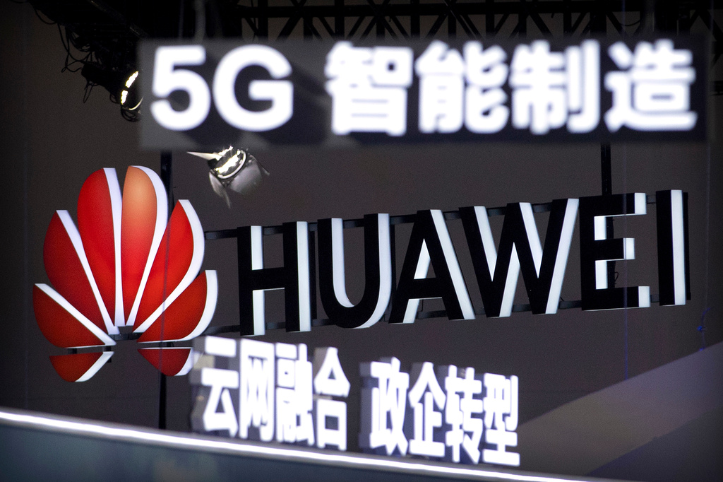 FILE - Signs promoting 5G wireless technology from Chinese technology firm Huawei are displayed at the PT Expo in Beijing on Sept. 26, 2018. (AP Photo/Mark Schiefelbein, File)