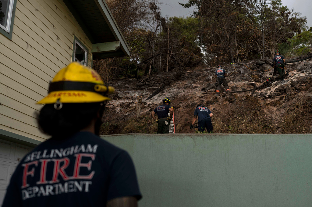 FILE - Firefighters clear debris in Kula, Hawaii, Aug. 15, 2023, following wildfires that devastated parts of the Hawaiian island of Maui. (AP Photo/Jae C. Hong, File)