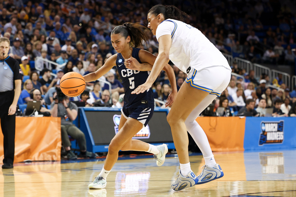 California Baptist guard Filipa Barros (5) drives against UCLA center Lauren Betts, right, during the first half in the first round of the NCAA college basketball tournament, Saturday, March 21, 2026, in Los Angeles. (AP Photo/Jessie Alcheh)